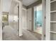 Hallway with carpet, doors leading to other rooms, and a view into the bathroom at 9911 Perry Ct, Westminster, CO 80031