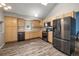 Spacious kitchen with modern appliances, light wood cabinets, and wood floors at 9911 Perry Ct, Westminster, CO 80031