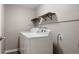 Functional laundry area equipped with a washer, dryer, and built-in shelving for storage at 9911 Perry Ct, Westminster, CO 80031
