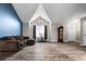 Open living space showcasing vaulted ceilings, a grand arched window, and stylish modern flooring at 9911 Perry Ct, Westminster, CO 80031