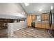 Open floor plan living area with wood floors, modern kitchen, and brick fireplace at 9911 Perry Ct, Westminster, CO 80031