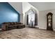 Bright living room with vaulted ceilings, large arched window, and modern flooring, complete with a classic grandfather clock at 9911 Perry Ct, Westminster, CO 80031