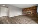 Spacious living room with wood-style flooring and a brick fireplace, perfect for entertaining guests at 9911 Perry Ct, Westminster, CO 80031