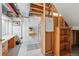 A functional basement area shows exposed beams, painted white walls, and storage shelving at 3548 W 126Th Pl, Broomfield, CO 80020