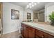 Bathroom boasts wood cabinets, tile countertop, and glass shower at 3548 W 126Th Pl, Broomfield, CO 80020