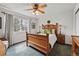 Bedroom showcasing a carved wooden bed frame, ceiling fan, and a window providing natural light at 3548 W 126Th Pl, Broomfield, CO 80020