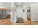 Bright entryway featuring hardwood floors, white walls and an adjacent powder room at 3548 W 126Th Pl, Broomfield, CO 80020