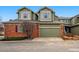 Charming townhouse showcasing a well-kept yard, two-car garage and brick accents at 3548 W 126Th Pl, Broomfield, CO 80020