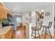 Well-lit kitchen with wood cabinets, breakfast bar, and stainless-steel appliances at 3548 W 126Th Pl, Broomfield, CO 80020