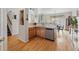 Well-lit kitchen and dining area features stone countertops and wood flooring at 3548 W 126Th Pl, Broomfield, CO 80020