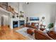 Cozy living room with fireplace, hardwood floors, and views to the stairway at 3548 W 126Th Pl, Broomfield, CO 80020