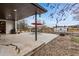 Expansive concrete back patio featuring an outdoor dining area and fire pit at 14290 W 54Th Ave, Arvada, CO 80002