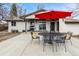 Back patio includes an outdoor dining set and a grill, perfect for enjoying outdoor meals at 14290 W 54Th Ave, Arvada, CO 80002