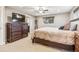 Bedroom with a ceiling fan and window, along with a dresser and mounted TV at 14290 W 54Th Ave, Arvada, CO 80002