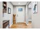 Cozy entryway with hardwood floors, a white front door, and decorative wall art at 14290 W 54Th Ave, Arvada, CO 80002