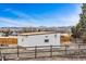 Exterior shot showing large storage shed in fenced-in backyard with mountain views at 14290 W 54Th Ave, Arvada, CO 80002