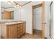 Bathroom with double sink vanity, large mirror, and walk in closet for ample storage at 2019 S Fox St, Denver, CO 80223