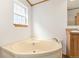 Bathroom featuring corner soaking tub with window and a view at 2019 S Fox St, Denver, CO 80223