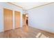 Large bedroom showcasing wood-look flooring and an abundance of closet space with a view towards the kitchen at 2019 S Fox St, Denver, CO 80223