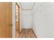 Walk in closet with ample storage shelves and luxury vinyl plank flooring at 2019 S Fox St, Denver, CO 80223