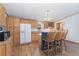 Kitchen with wood cabinets, island with breakfast bar, and stainless-steel microwave at 2019 S Fox St, Denver, CO 80223