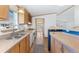 Kitchen with wood cabinets and modern white appliances with luxury vinyl plank flooring at 2019 S Fox St, Denver, CO 80223
