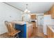 Bright kitchen with a breakfast bar, wood cabinets, and modern appliances at 2019 S Fox St, Denver, CO 80223