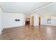 Spacious living room with wood flooring, white walls, and adjacent kitchen view at 2019 S Fox St, Denver, CO 80223
