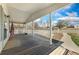 Inviting covered porch with wooden floors, white railings, and views of the neighborhood at 2019 S Fox St, Denver, CO 80223