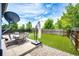 Landscaped backyard featuring lush, manicured lawn, patio seating, and a privacy fence at 5794 S Yakima Way, Aurora, CO 80015