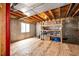 Unfinished basement with exposed ceiling and flooring with visible support beams and a window at 5794 S Yakima Way, Aurora, CO 80015