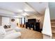 A finished basement featuring carpet, a large TV, a ceiling fan, and a couch at 5794 S Yakima Way, Aurora, CO 80015