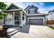 Suburban home with a charming front porch and a two-car garage, complete with a well-maintained driveway at 5794 S Yakima Way, Aurora, CO 80015