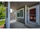 Cozy front porch features white pillars, a window, and a door, creating a welcoming entrance at 5794 S Yakima Way, Aurora, CO 80015