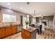 Open kitchen with an island and stainless steel appliances at 5794 S Yakima Way, Aurora, CO 80015
