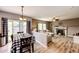 Inviting living and dining area boasts an open layout with modern decor, hardwood floors, and natural light at 5794 S Yakima Way, Aurora, CO 80015