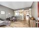 Open-concept living room boasts modern decor, wood floors, and seamless flow into the dining area at 5794 S Yakima Way, Aurora, CO 80015