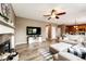 Cozy living area featuring a fireplace, comfortable seating, hardwood floors, and an open layout to the kitchen at 5794 S Yakima Way, Aurora, CO 80015