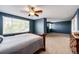 A spacious main bedroom features blue walls, carpet, and lots of natural light at 5794 S Yakima Way, Aurora, CO 80015
