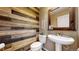 Powder room with modern sink and rustic wood wall at 22991 E Roxbury Dr # B, Aurora, CO 80016