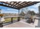 The back deck features an outdoor dining area, bar-style seating, and a view of the backyard at 23841 E Alabama Dr, Aurora, CO 80018