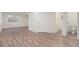 Open basement area with wood-look flooring, a window, and a convenient half bathroom at 23841 E Alabama Dr, Aurora, CO 80018