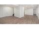 Spacious finished basement features wood-look floors, neutral walls, and ample space for living at 23841 E Alabama Dr, Aurora, CO 80018