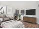 Well-staged bedroom showcasing modern decor, stylish furniture, and wood-look flooring at 23841 E Alabama Dr, Aurora, CO 80018