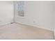 Empty bedroom with neutral carpet, a window, and ample natural light at 23841 E Alabama Dr, Aurora, CO 80018