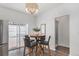 Cozy breakfast nook features a round table, modern light fixture, and sliding glass door to a patio at 23841 E Alabama Dr, Aurora, CO 80018