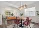 Cozy dining area with modern light fixture, seating for four, open to the living room at 23841 E Alabama Dr, Aurora, CO 80018