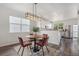Cozy dining area with modern light fixture, seating for four, and hardwood floors at 23841 E Alabama Dr, Aurora, CO 80018