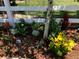 Bright flower garden with white picket fence and mulch at 23841 E Alabama Dr, Aurora, CO 80018