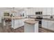 Bright kitchen with white cabinetry, stainless steel appliances, granite countertops, and island at 23841 E Alabama Dr, Aurora, CO 80018